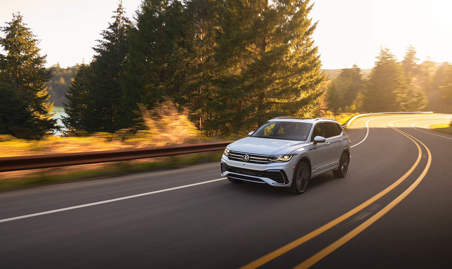 Rear view shot of the 2022 Volkswagen Tiguan driving down a 2 lane highway